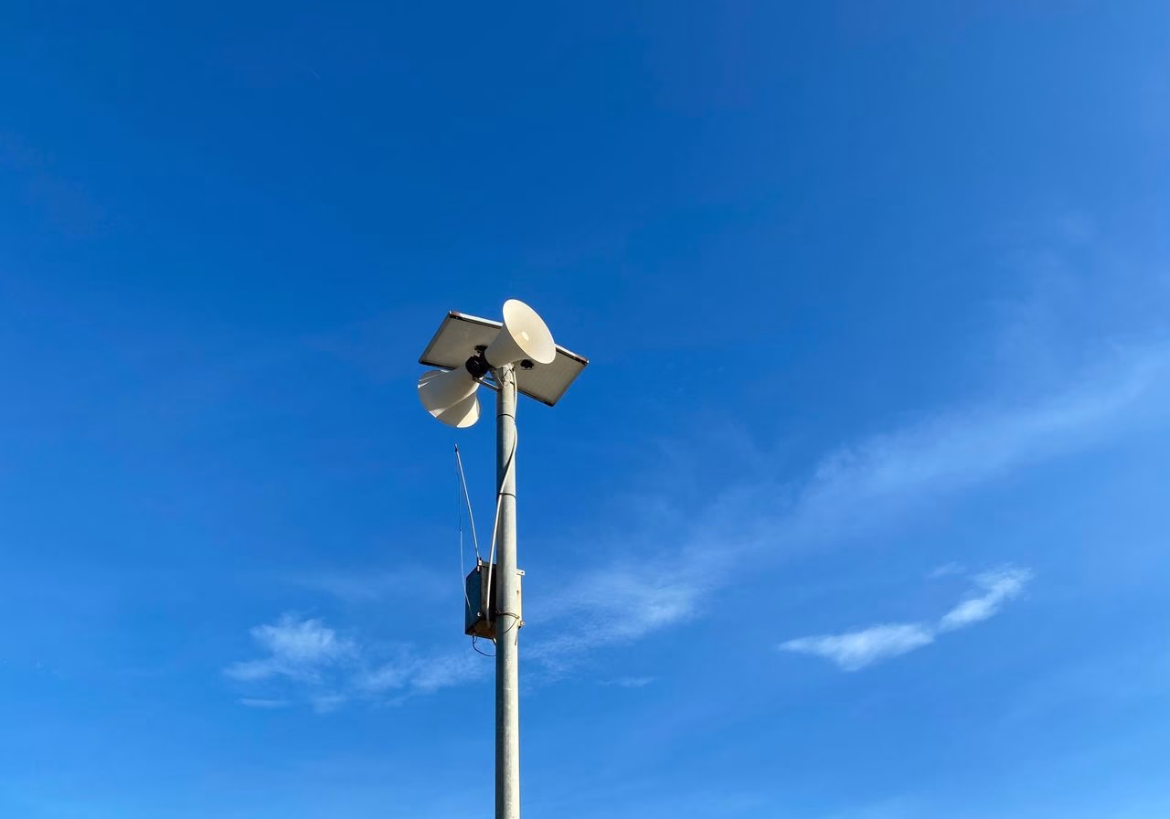 pexels-photo-12375133-12375133 A communication tower with antenna against a bright blue sky, showcasing technology and connectivity.